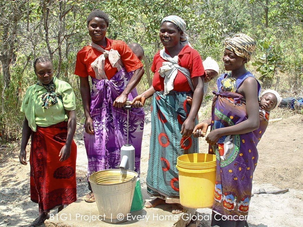A Group Of Women Are Standing Next To Each Other Holding Buckets Of Water — The Garis Group In Hamilton, NSW A Group Of Women Are Standing Next To Each Other Holding Buckets Of Water — The Garis Group In Hamilton, NSW