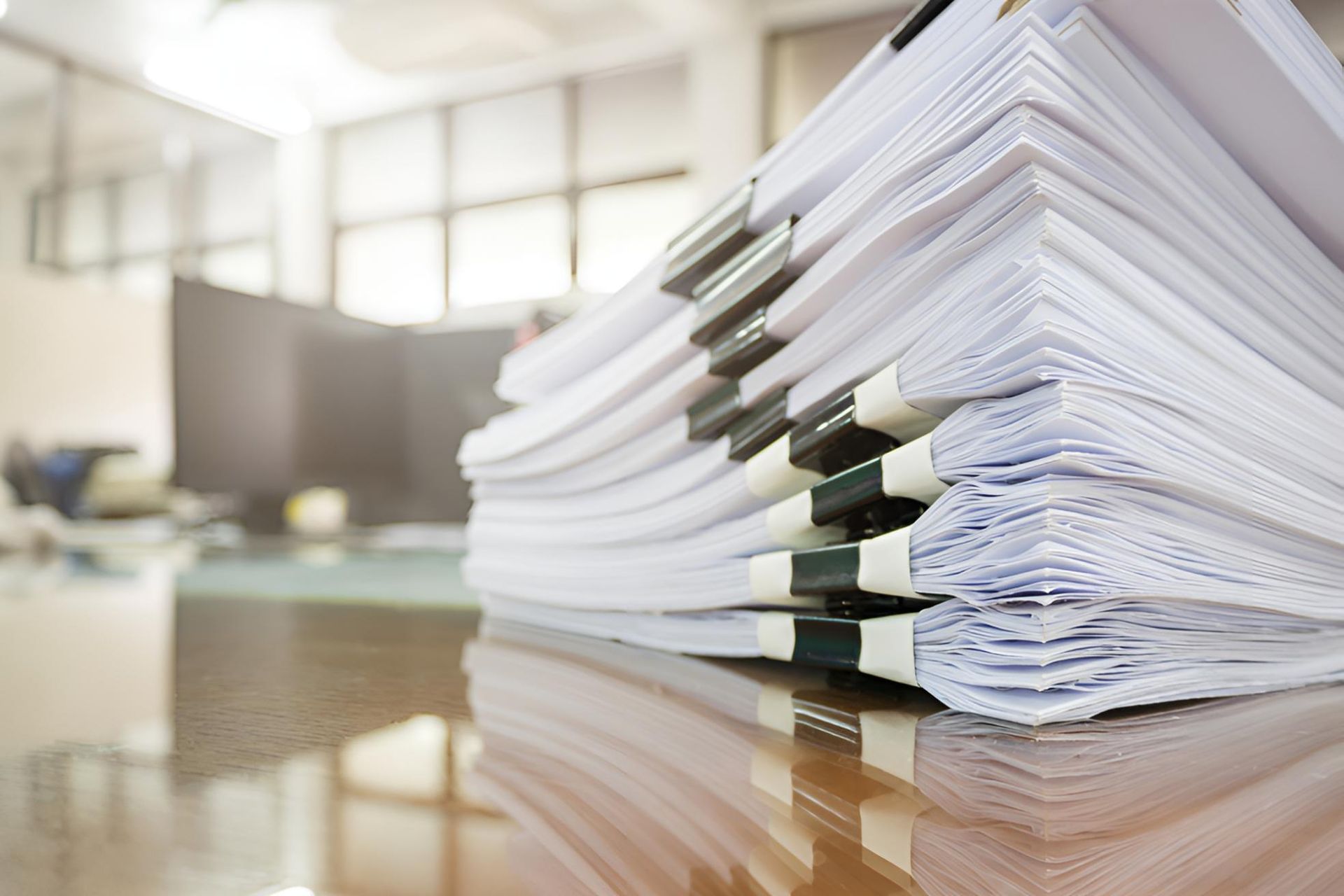 A Stack of Papers is Sitting on a Table — The Garis Group In Hamilton, NSW