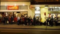 A Large Group Of People Are Standing Outside Of A Building — The Garis Group In Hamilton, NSW A Large Group Of People Are Standing Outside Of A Building — The Garis Group In Hamilton, NSW