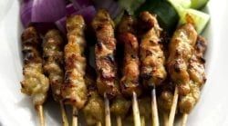 A White Plate Topped With Skewers Of Meat And Vegetables — The Garis Group In Hamilton, NSW A White Plate Topped With Skewers Of Meat And Vegetables — The Garis Group In Hamilton, NSW