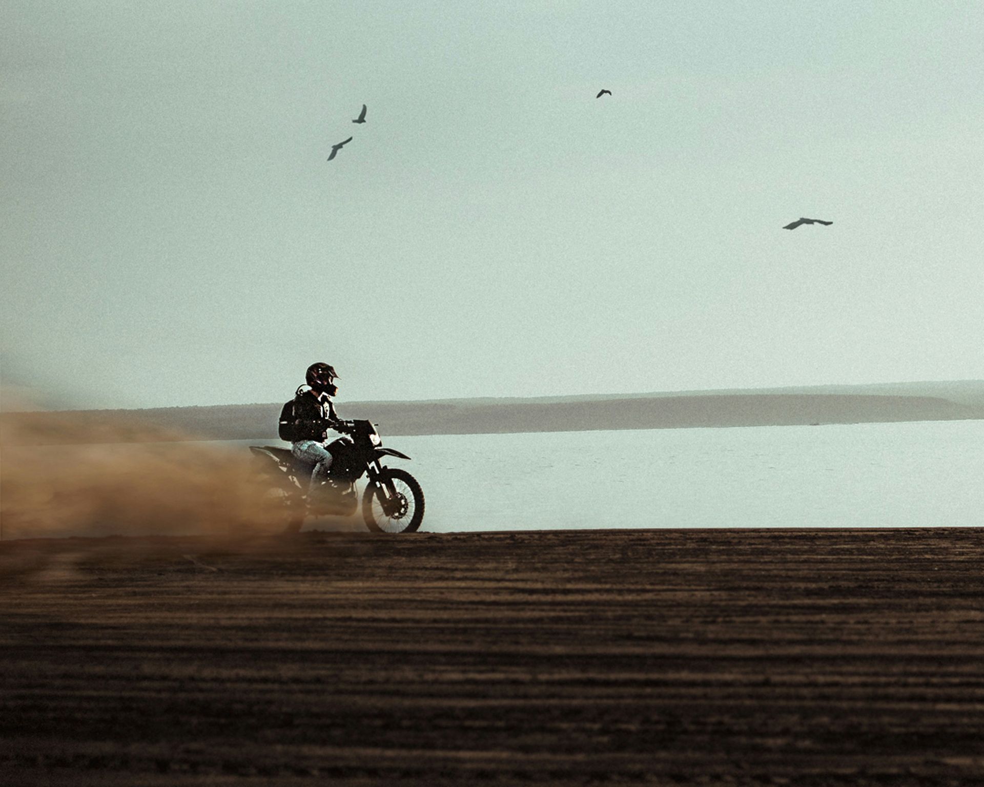 a person riding a dirt bike on a dirt road