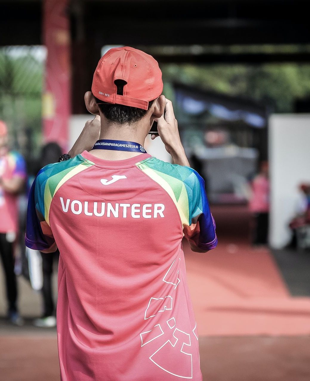 a man wearing a volunteer shirt takes a picture