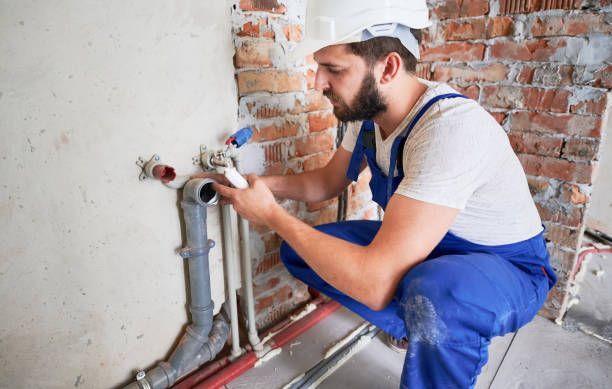 Plumber in action, representing precise sewer pipe sealant application during pipe repair.