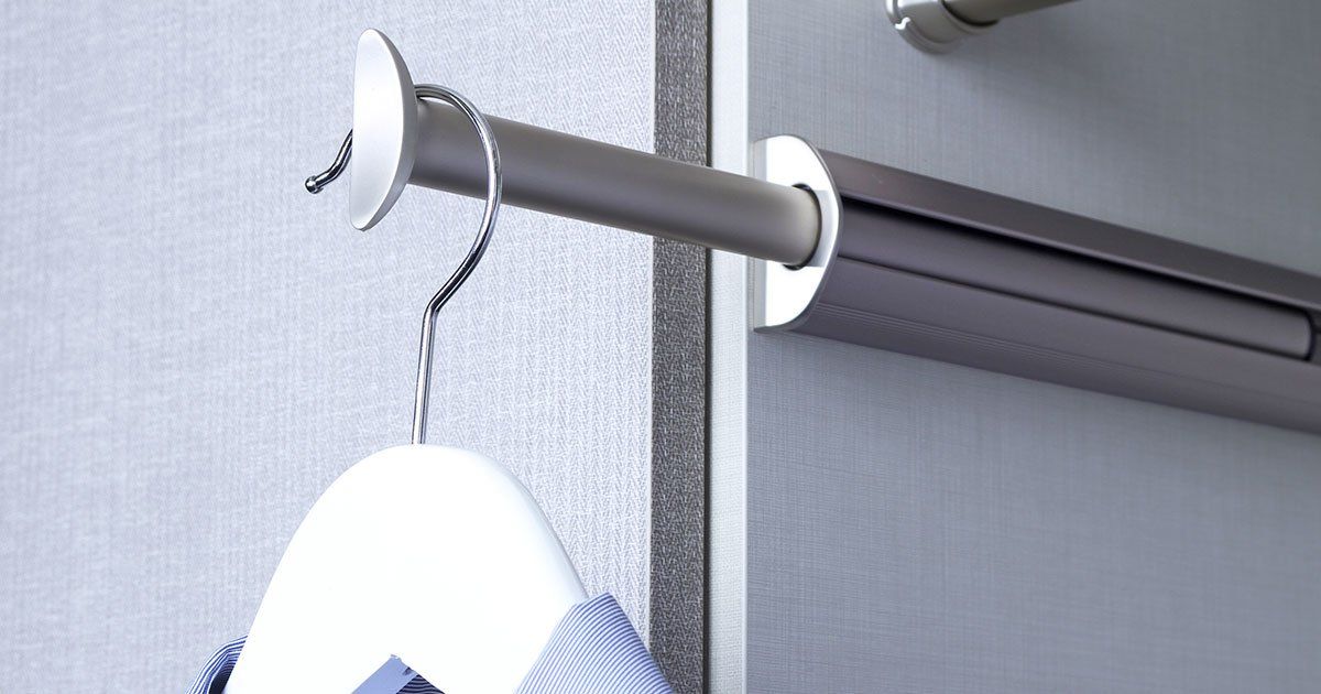 a shirt is hanging on a hanger in a closet .