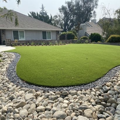 rock filled planter surrounding artificial grass