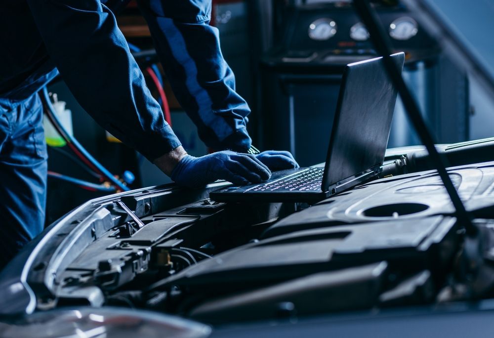 Technician Using a Laptop to Diagnose a Car Engine — Hive Mobile Roadworthy in Ashmore, QLD