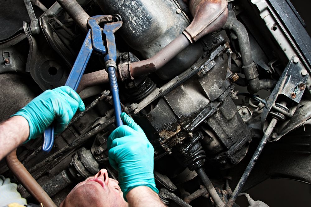 Mechanic in Blue Gloves Using Tools to Repair an Engine — Hive Mobile Roadworthy in Paradise Point, QLD