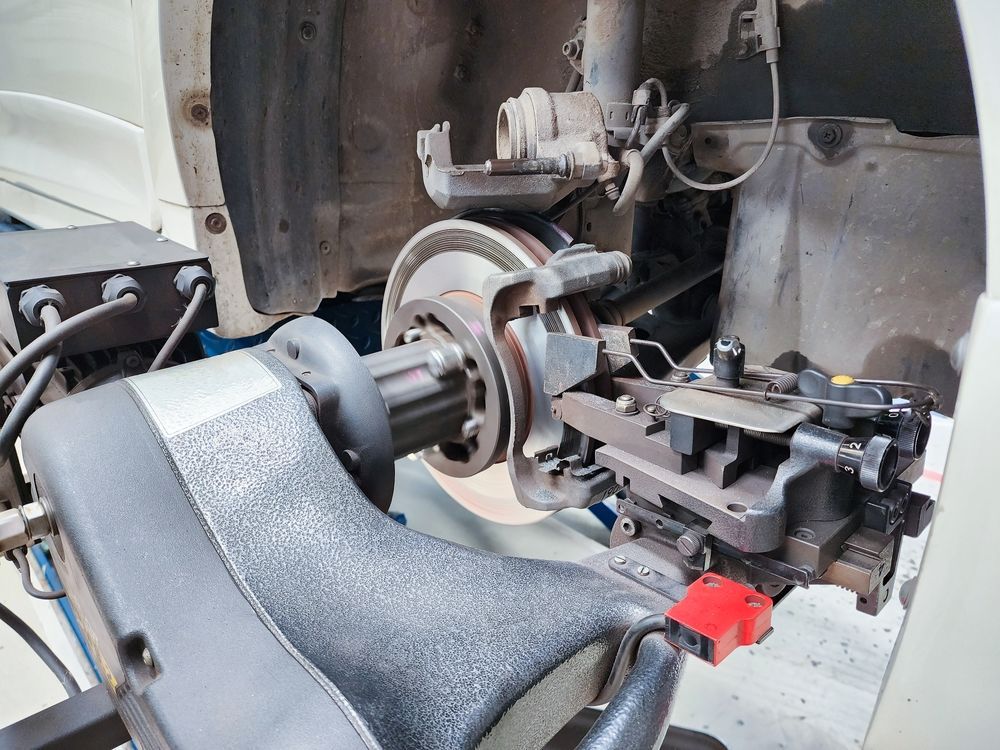 Car Brake Rotor and Caliper Being Serviced With Tools — Hive Mobile Roadworthy in Varsity Lakes, QLD