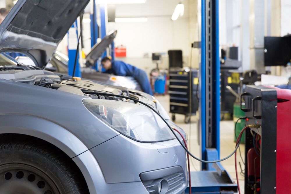 A Car is Being Repaired in a Garage With the Hood Open — Hive Mobile Roadworthy in Robina, QLD