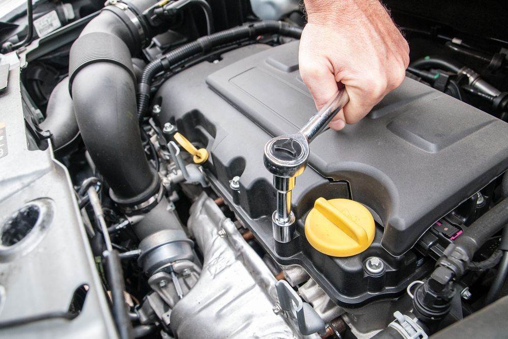 A Person is Working on the Engine of a Car With a Wrench — Hive Mobile Roadworthy in Mount Nathan, QLD