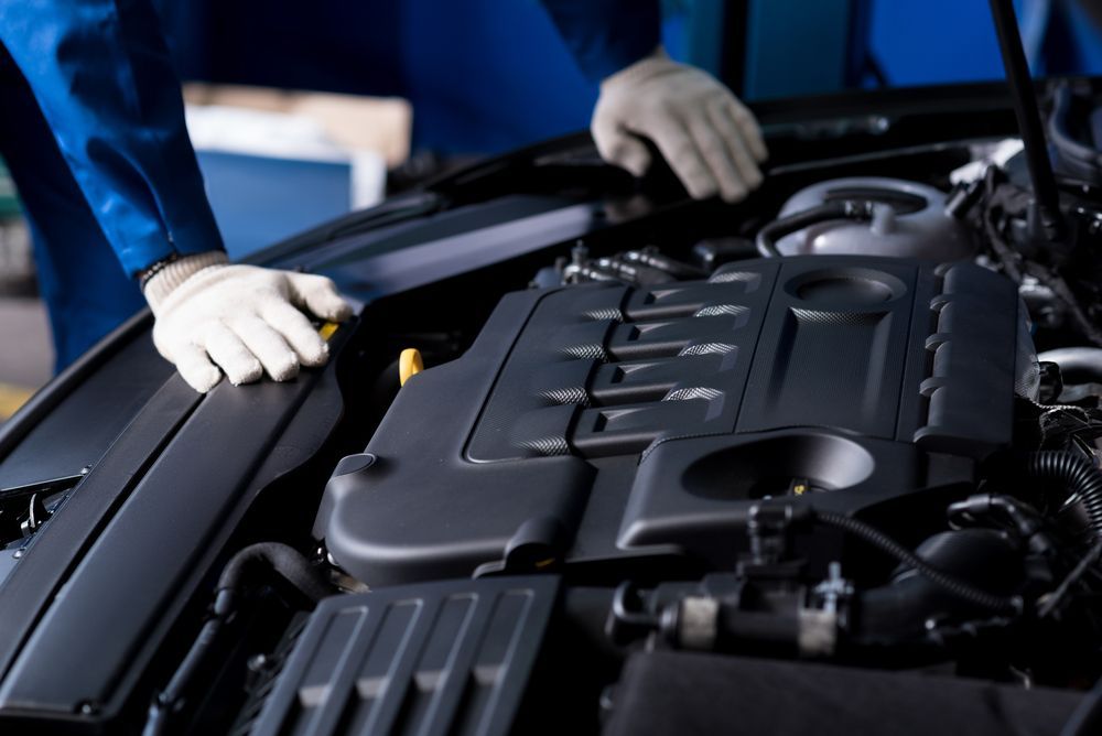 A Mechanic is Working on the Engine of a Car — Hive Mobile Roadworthy in Helensvale, QLD
