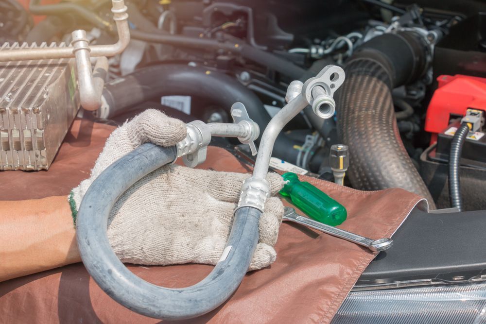 Car Engine Bay With a Detached Hose, Wrench, and Screwdriver — Hive Mobile Roadworthy in Ashmore, QLD