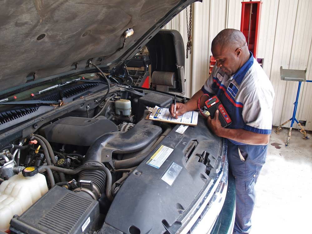 Mechanic Inspecting a Car Engine With the Hood Open — Hive Mobile Roadworthy in Currumbin, QLD
