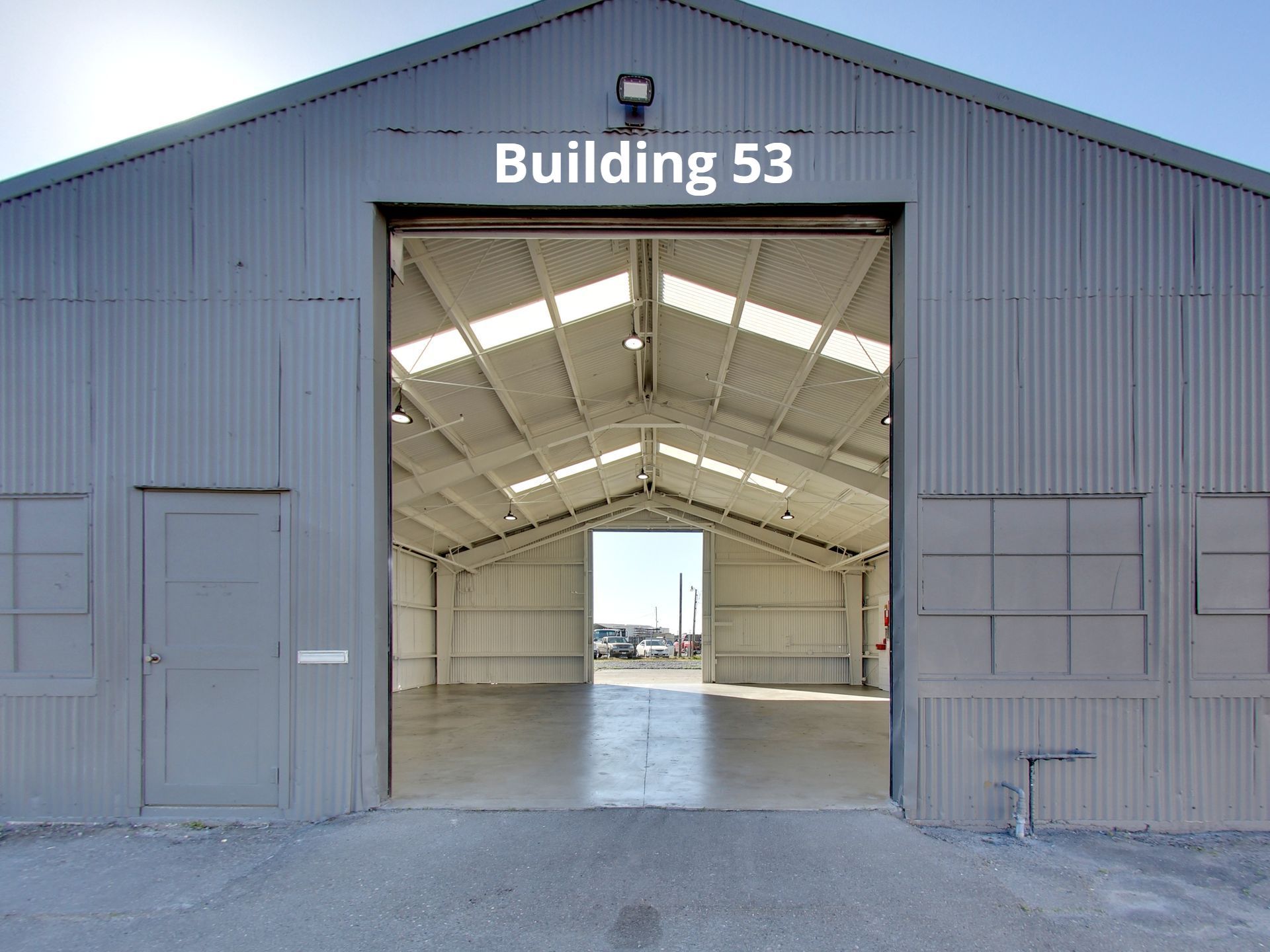 Photo of warehouse with large hanger door open