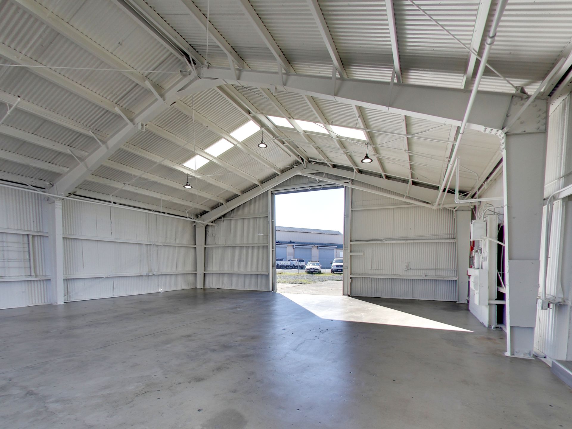 Photo of warehouse interior with large hanger door open