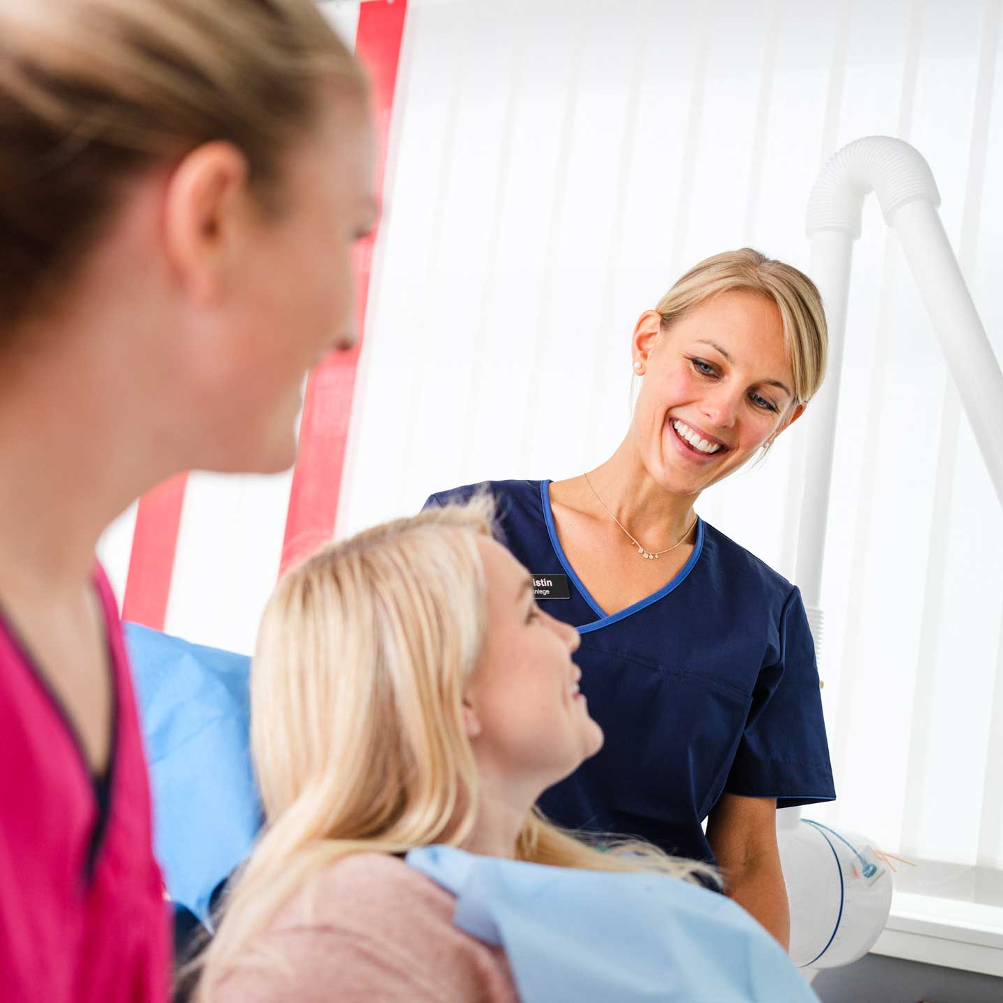 Dentist Kristin and a patient smiling to each other
