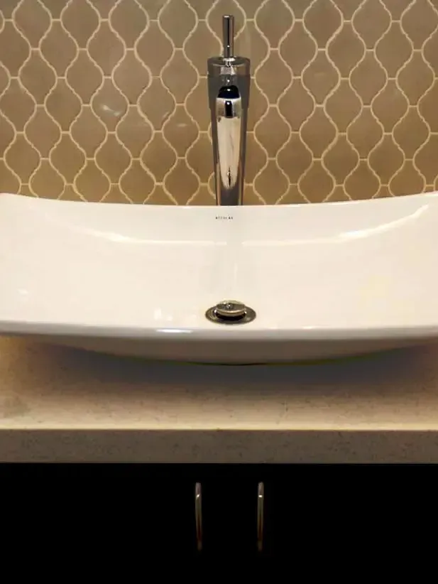 A bathroom sink with a faucet on top of it.