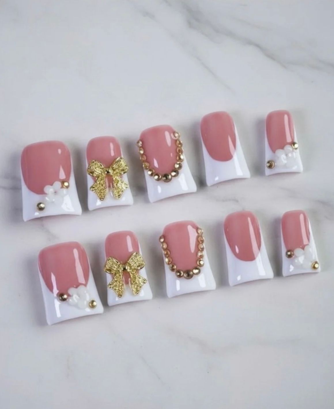 Chic short French tip nails adorned with elegant golden bows