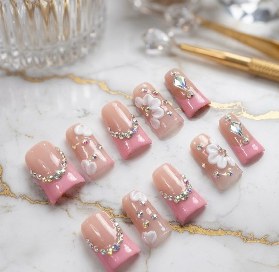 Elegant Pink French Tip Nails with Charming Floral Patterns.