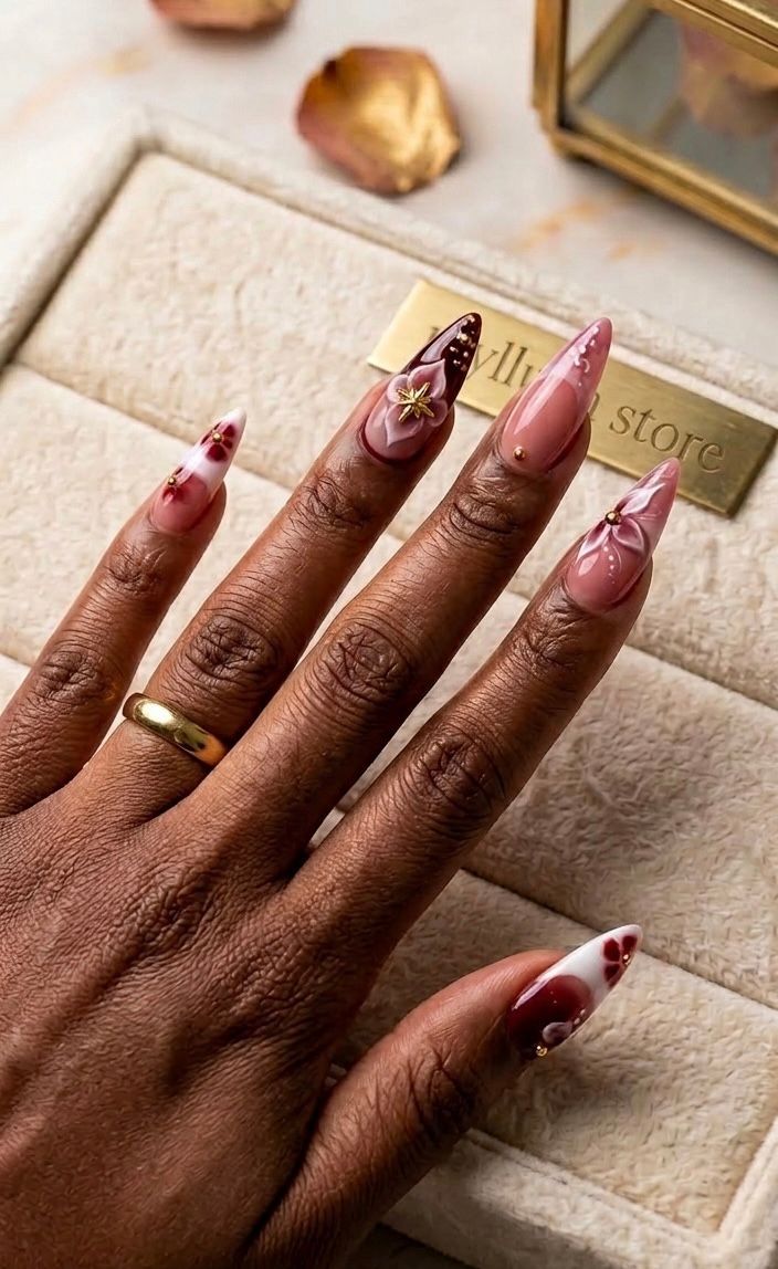 Vibrant red floral-patterned stiletto acrylic nails.