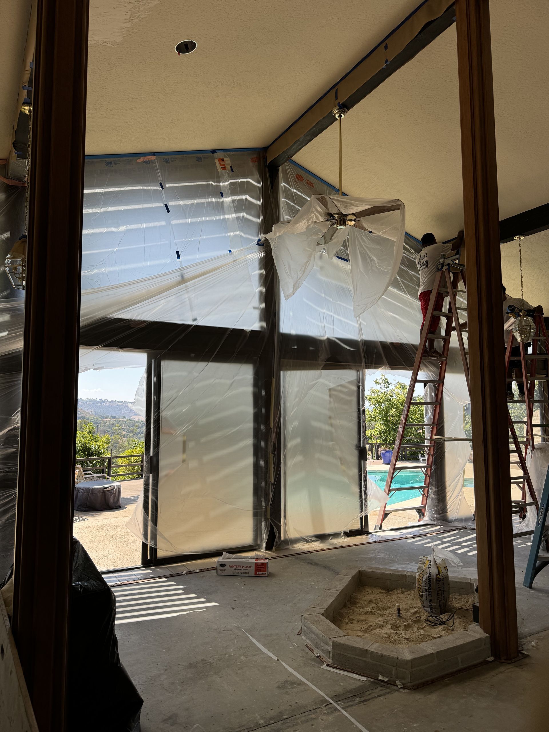 Damaged glass storefront with shattered panels and debris on the floor, daylight streaming in