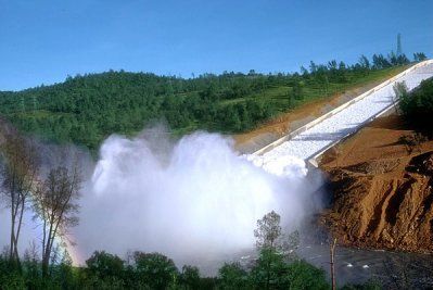 A large amount of water is coming out of a dam.