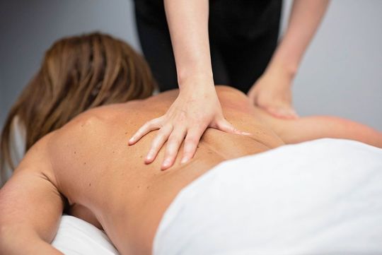 a woman is getting a massage on her back