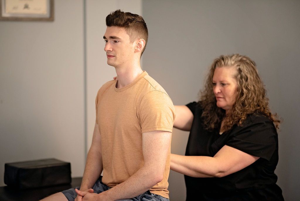 a woman is giving a man a massage on his back