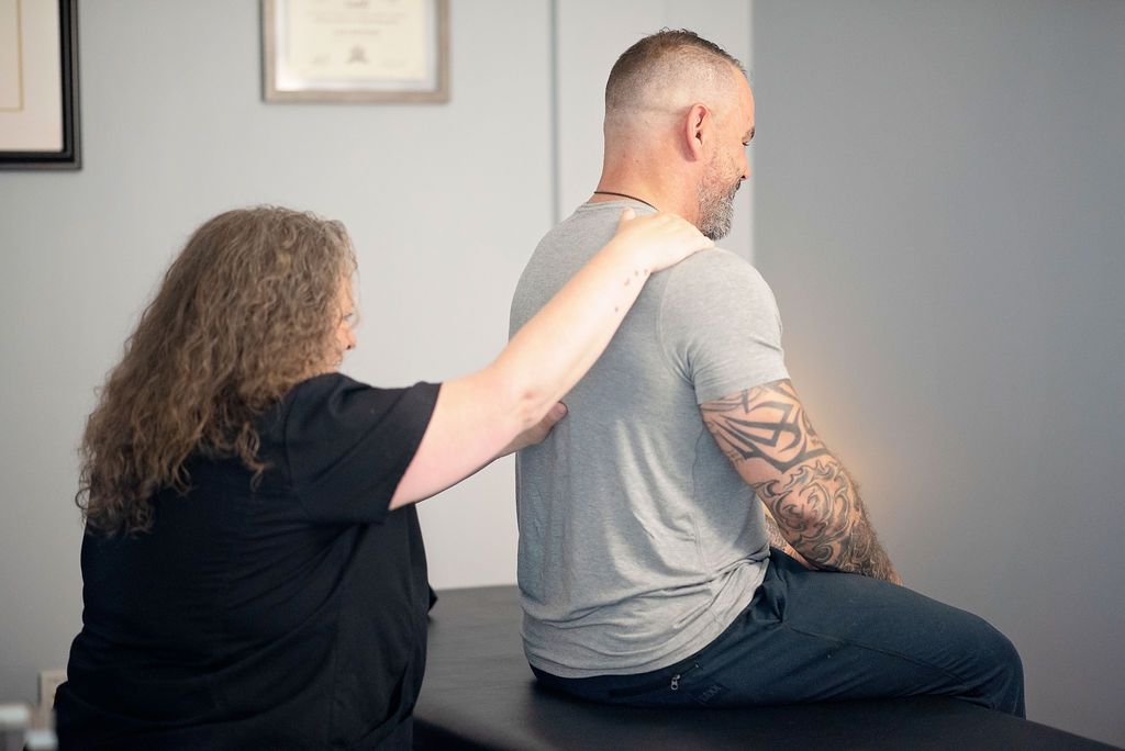 a man with a tattoo on his arm is being examined by a woman