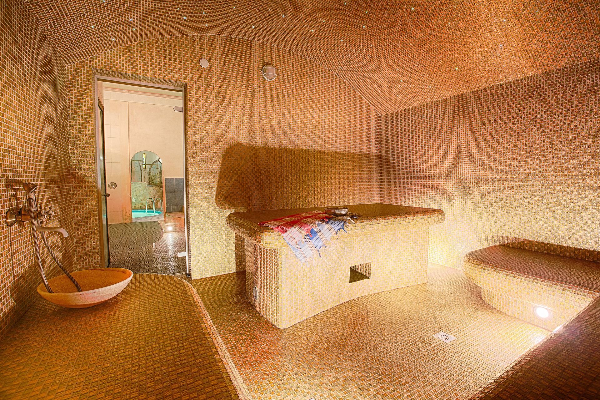 a bathroom with a sink and a table with a towel on it
