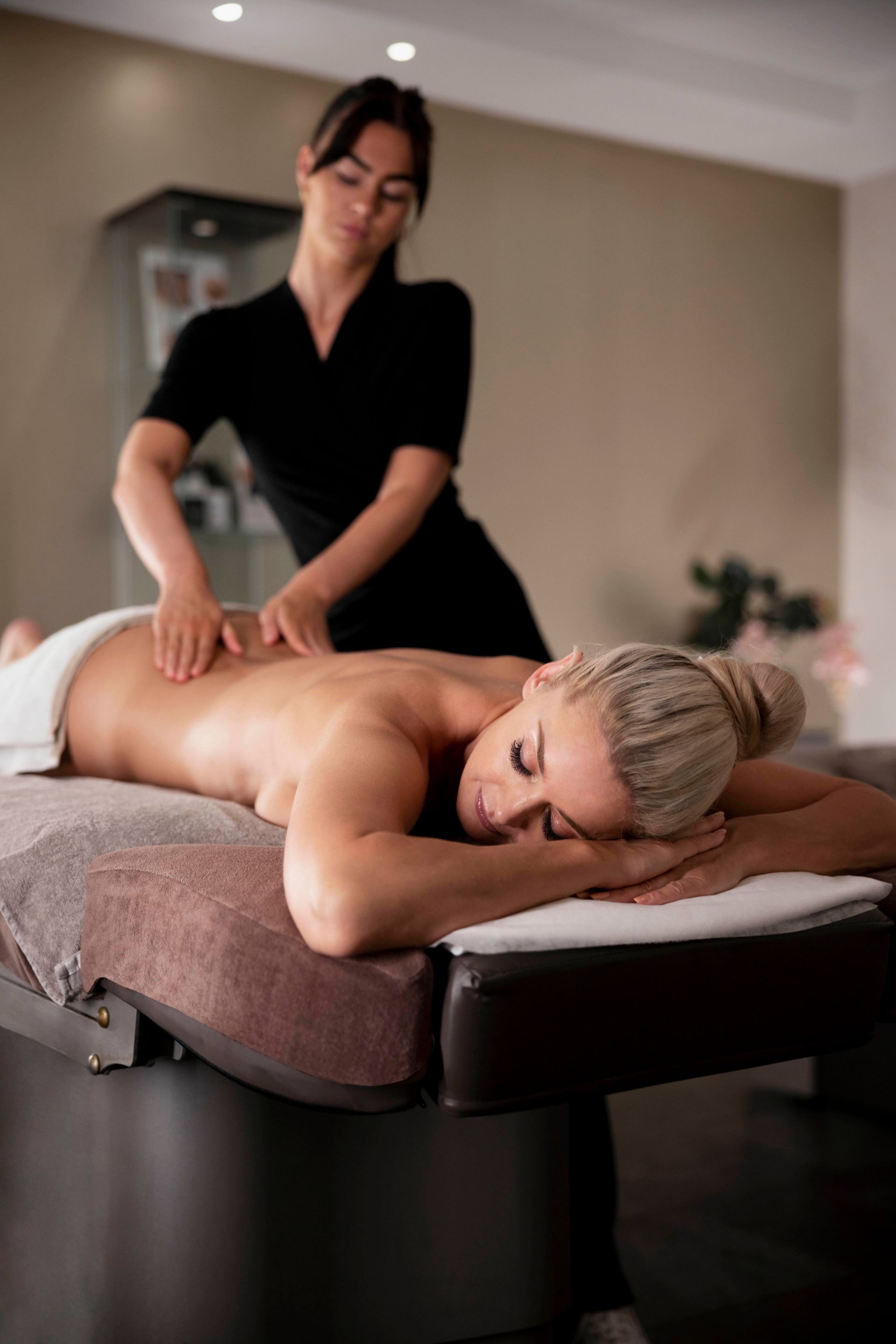 a woman is laying on a table getting a massage
