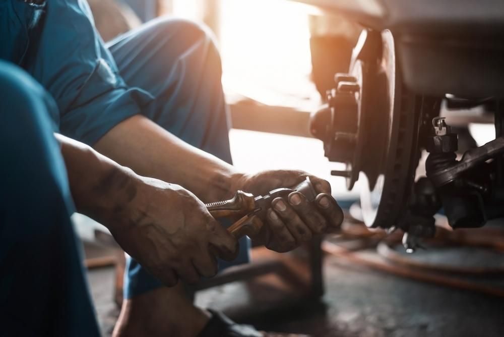 A Mechanic Is Working on A Vehicle in A Garage — TGR Automotive–Honda Specialist in Lismore, NSW