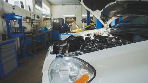 A White Car Is Being Repaired in A Garage with The Hood Open — TGR Automotive–Honda Specialist in Lismore, NSW