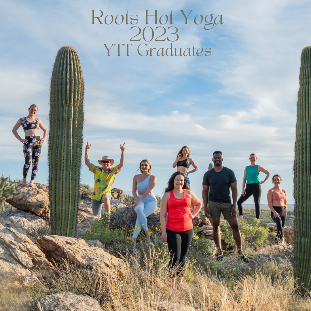 Group of people posing by cacti, celebrating Roots Hot Yoga YTT 2023 graduates in an outdoor setting.