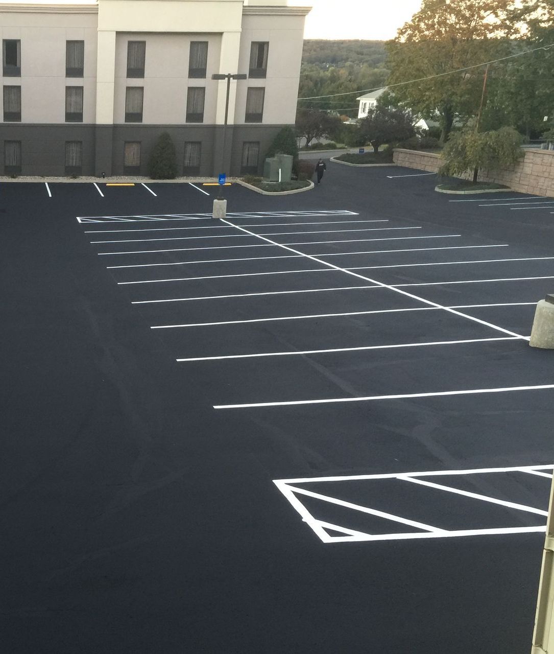 A parking lot with a building in the background