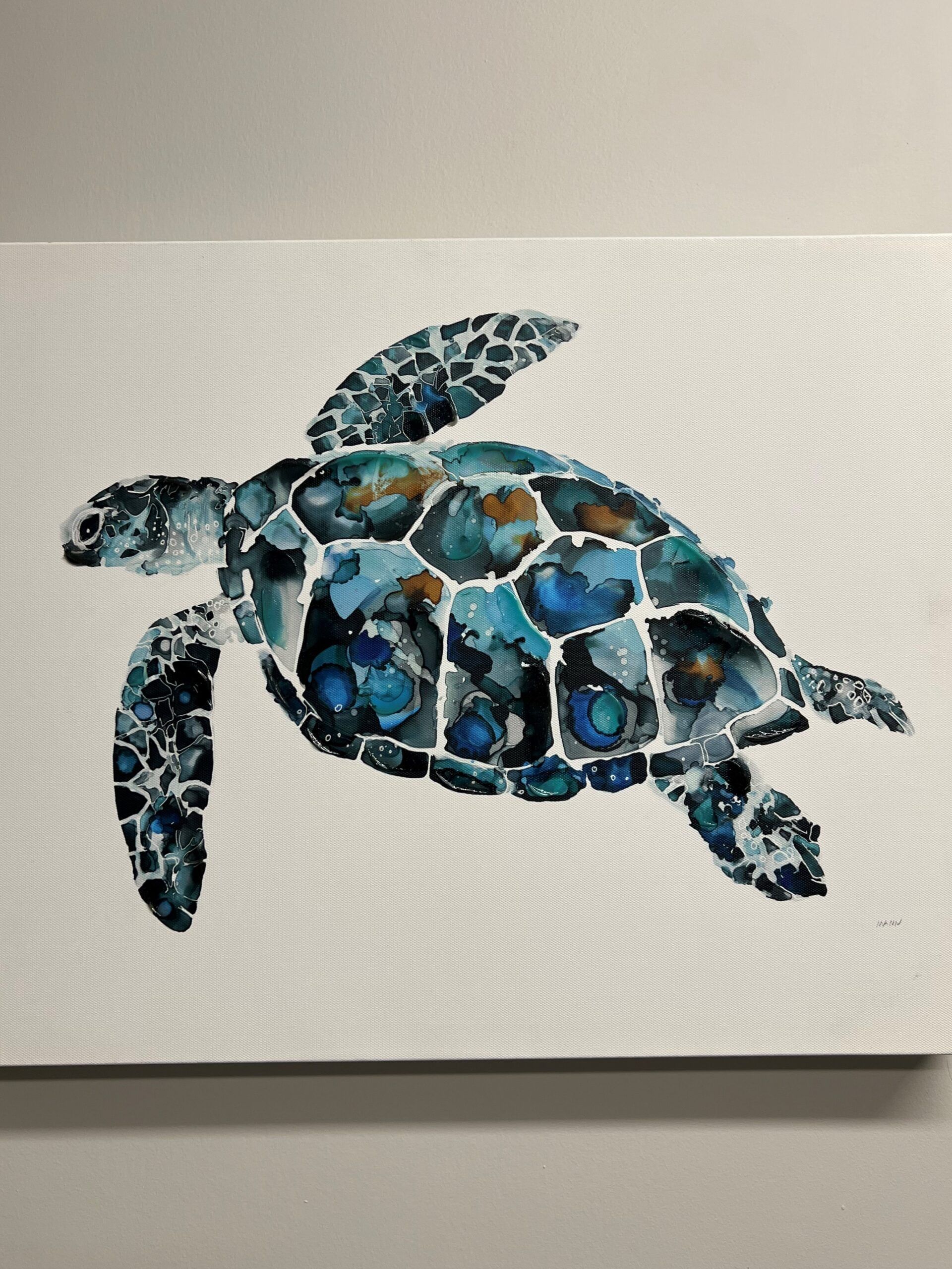 Blue mosaic sea turtle artwork on a light textured background