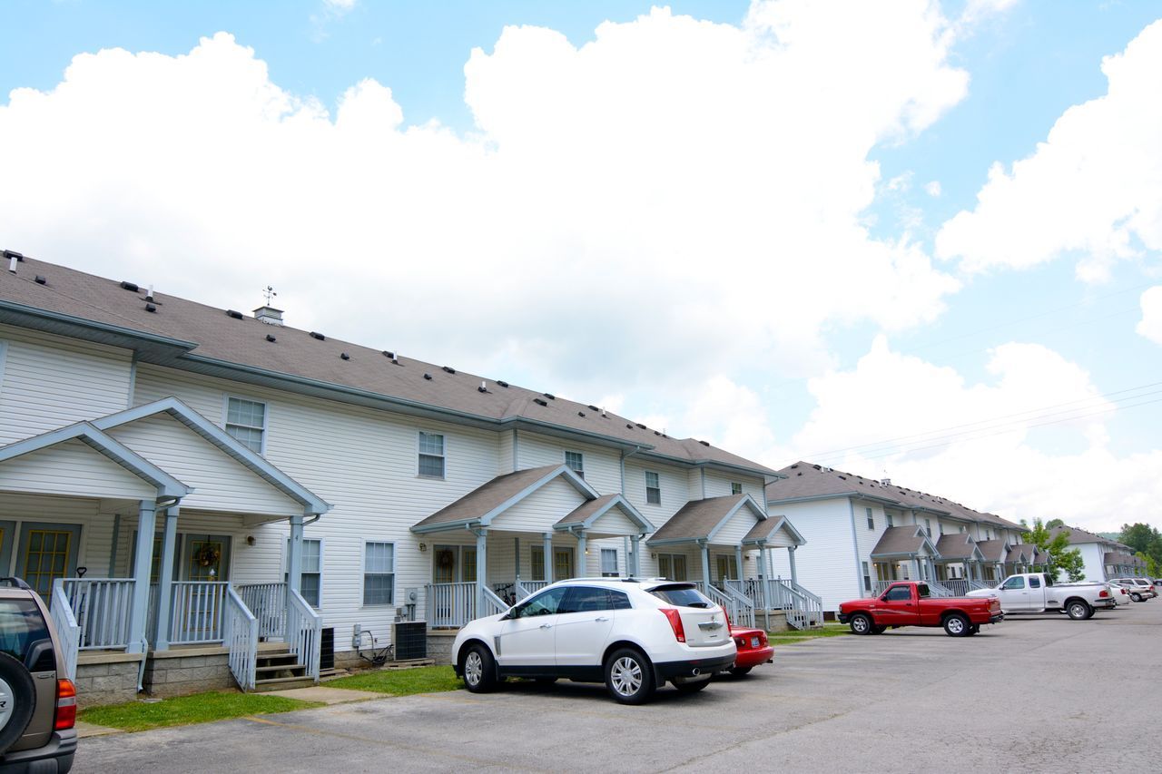 Exterior of Townhomes & Flats At MSU with parking lot