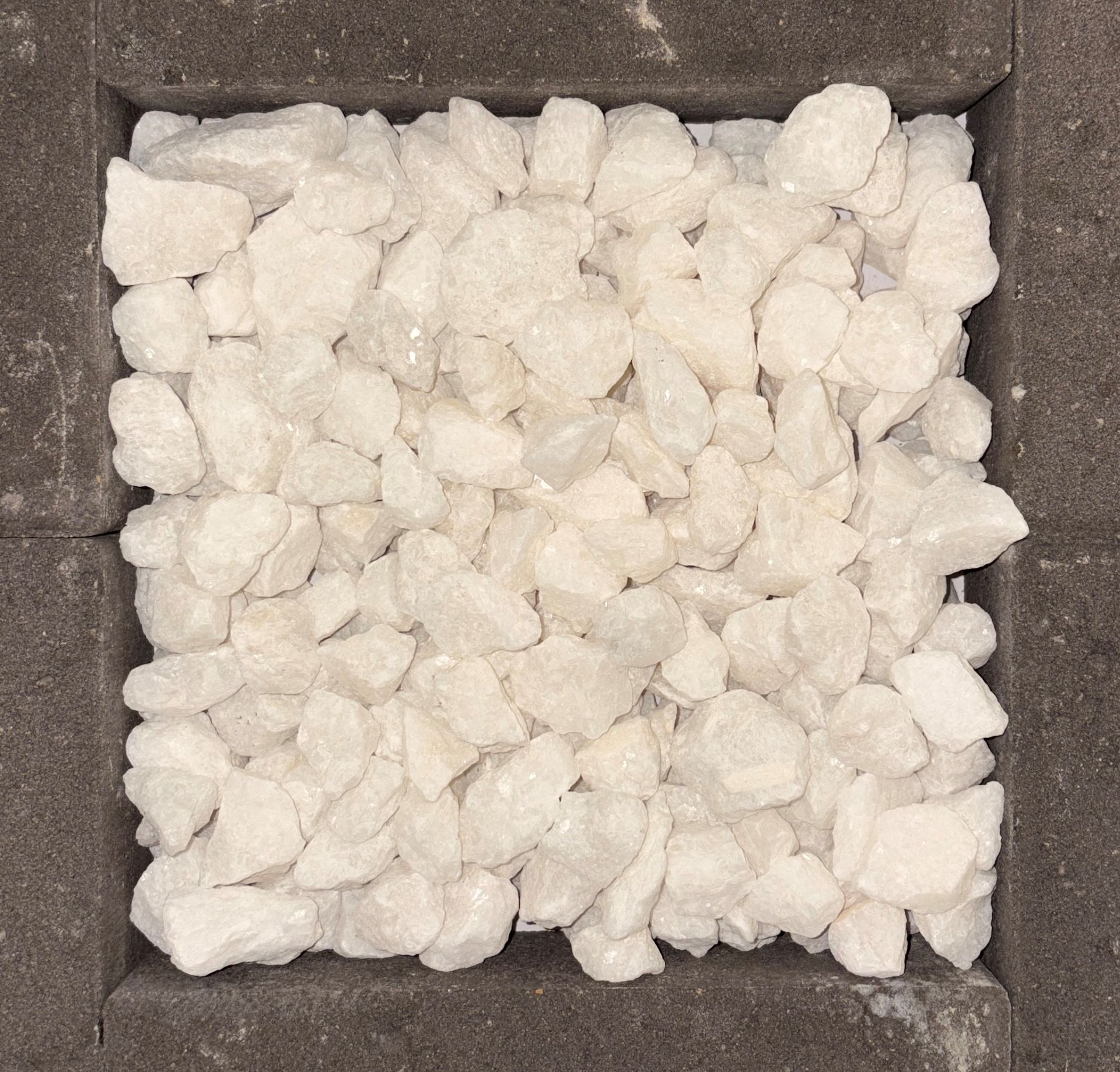 Square frame filled with white gravel. Dark gray border.