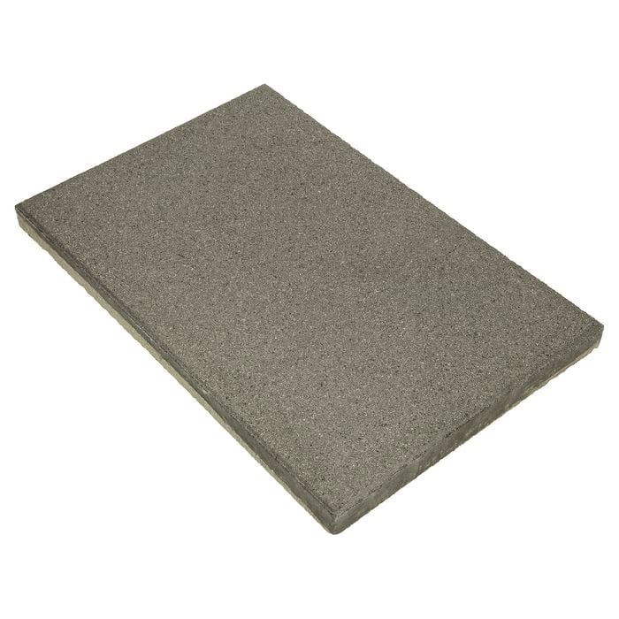 A piece of gray foam is sitting on a white surface