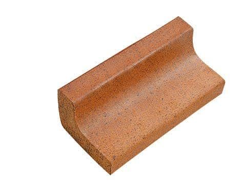Red brick curb with curved edge.