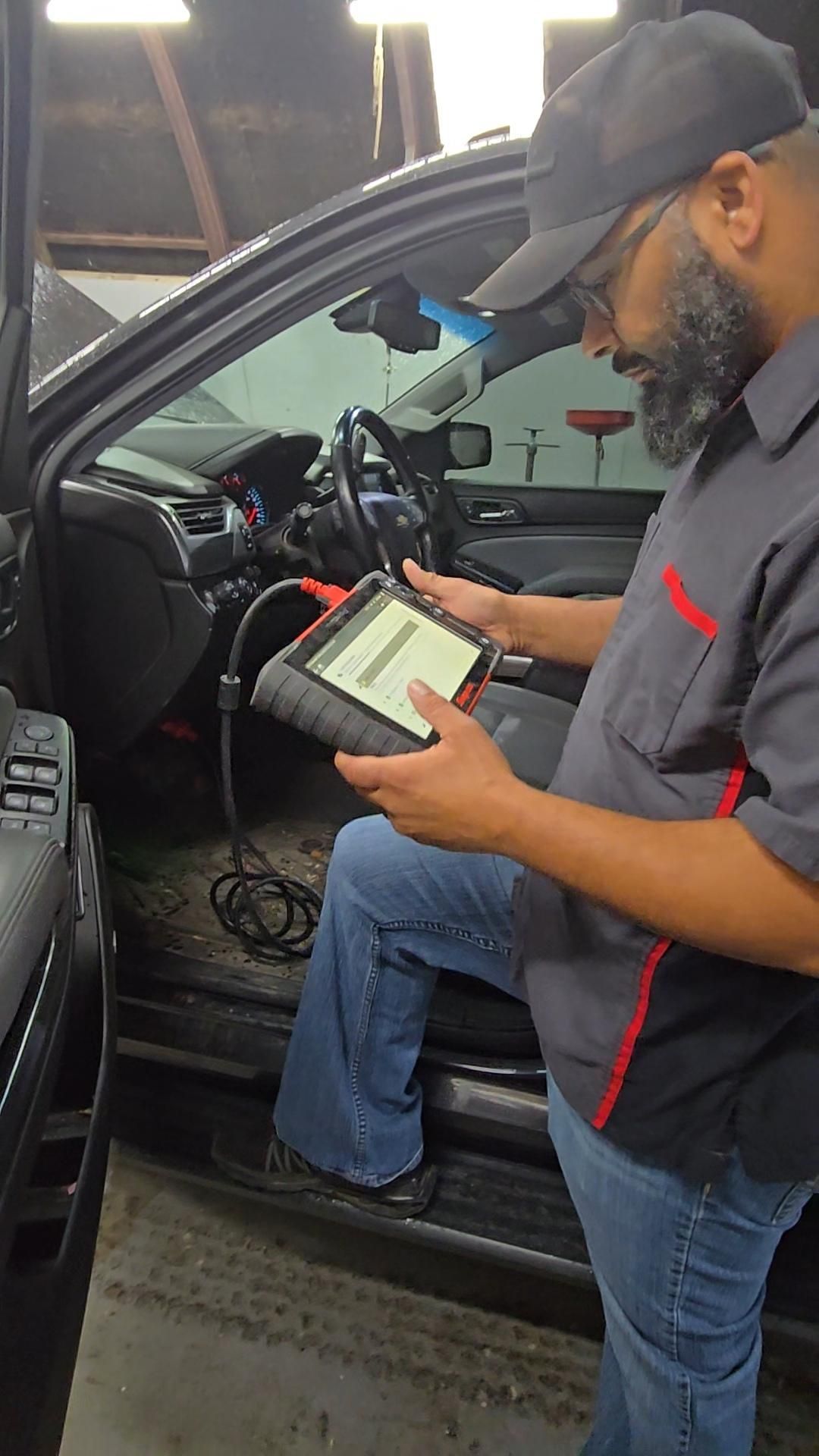 Technician Using Diagnostic Scanner Inside Vehicle | Burnout Boyz Garage LLC