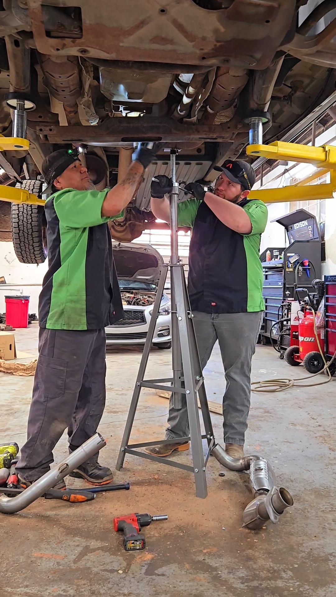 Technicians Working Under A Vehicle On A Lift | Burnout Boyz Garage LLC