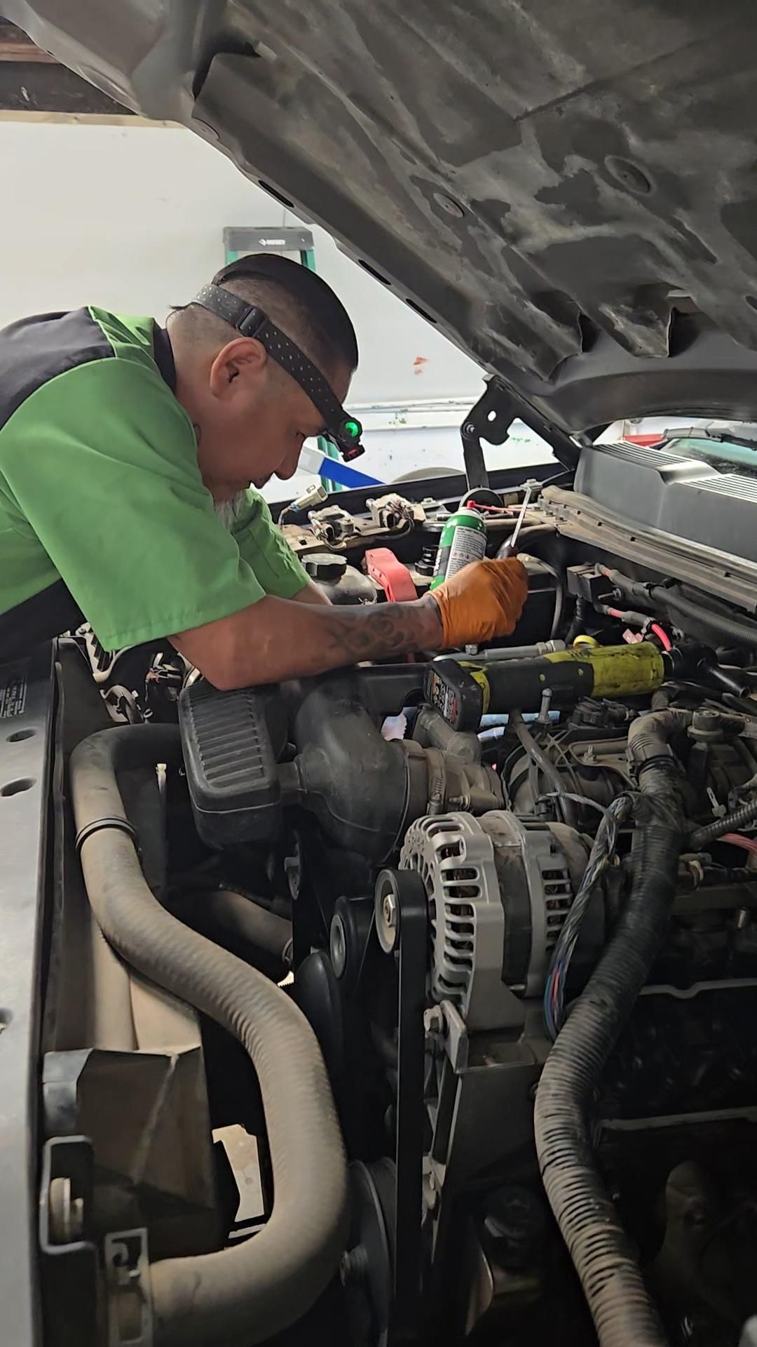 Mechanic Performing Engine Repair Under An Open Hood | Burnout Boyz Garage LLC
