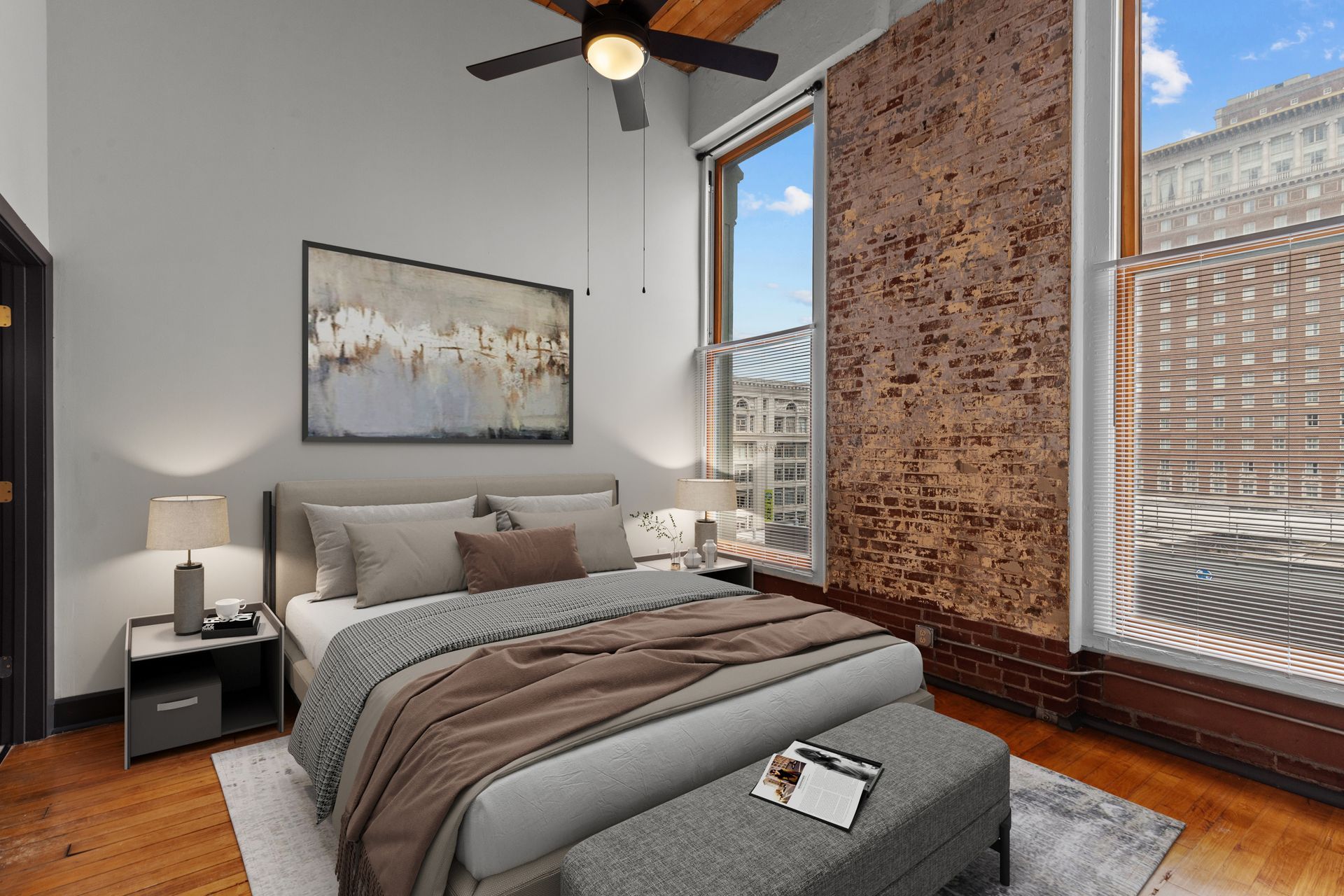 Modern bedroom with bed, nightstands, ceiling fan, and large windows with city views.