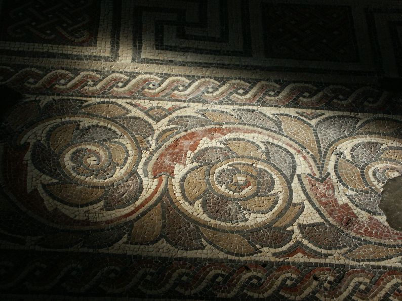 A close up of a mosaic floor with a greek key pattern