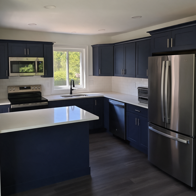 Modern kitchen with navy cabinets, stainless steel appliances, and a central island by a window