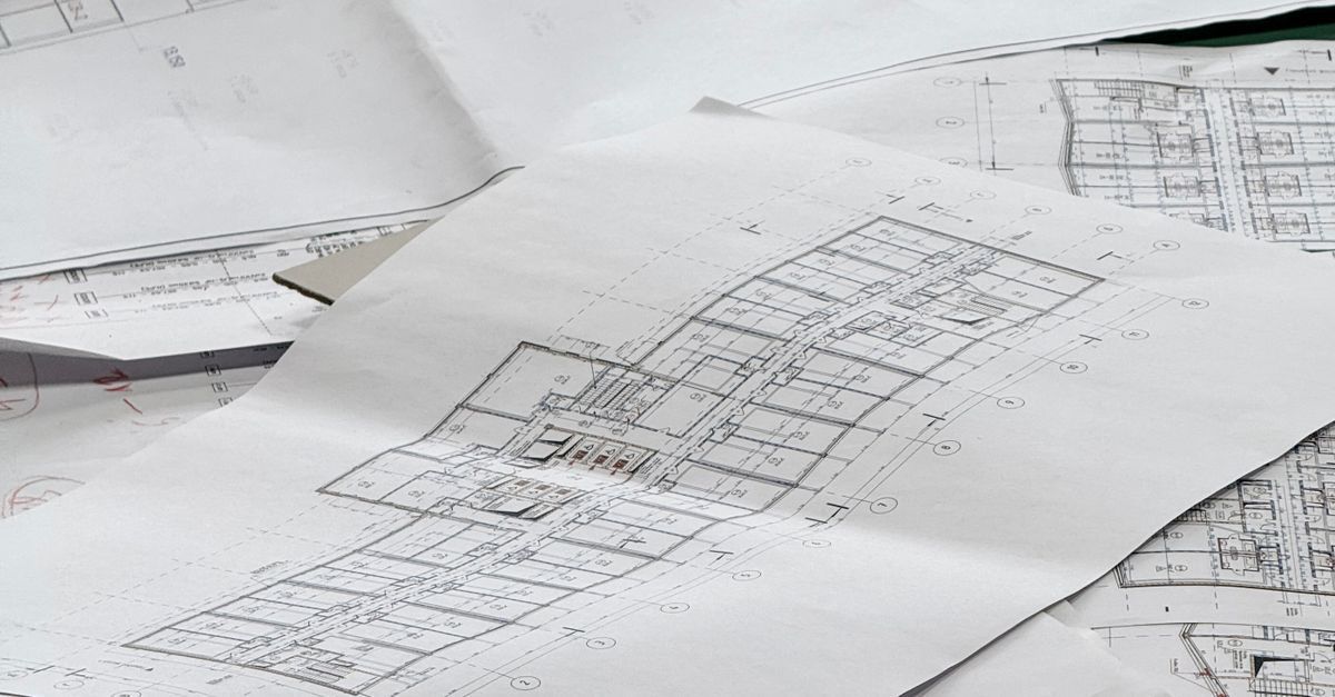 ADU floor plans and pencil on a table during permit planning