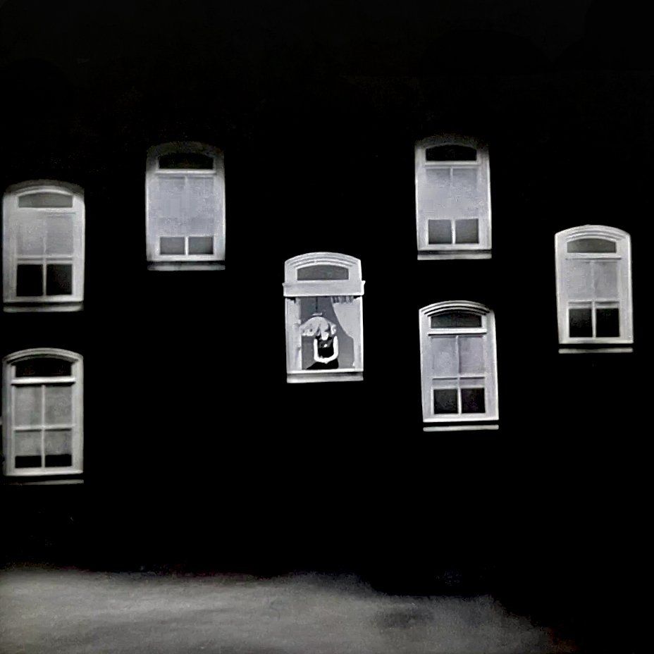 Wide shot of Streisand on the Ed Sullivan Show singing on a set of windows.