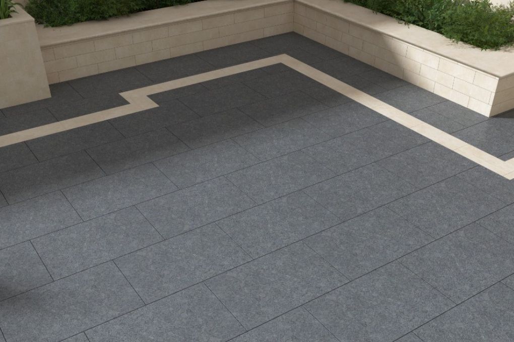 dark granite paving with a light inside border