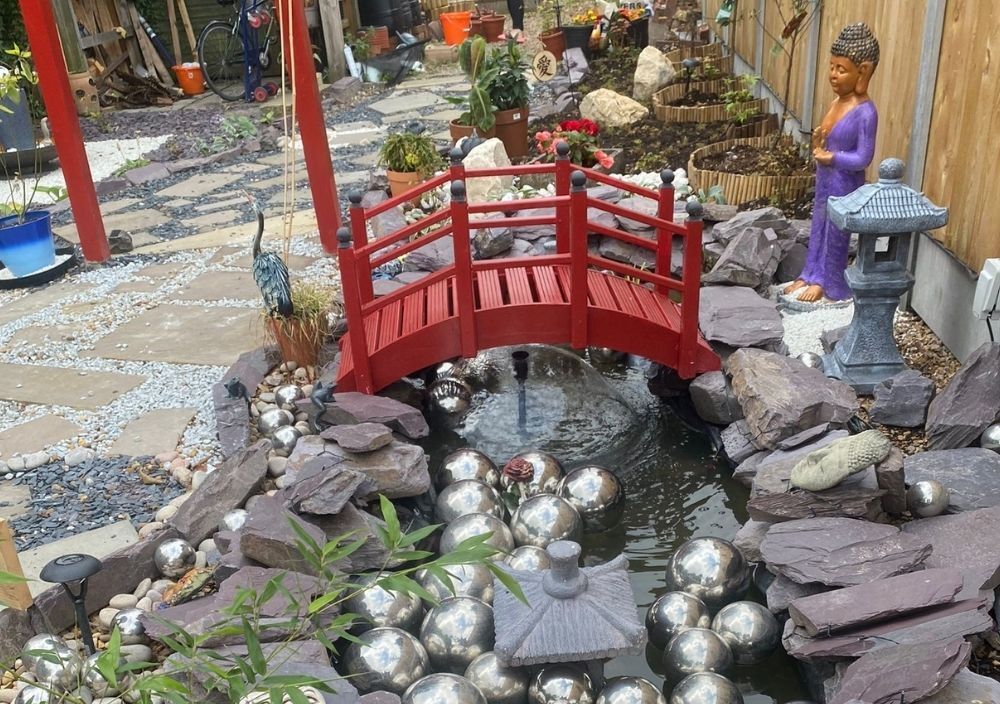 Japanese garden in Bramhope with a red footbridge over a pond